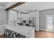 Bright kitchen featuring a large island, white cabinets, stainless steel appliances, and hardwood floors at 1826 Hall Ave, Charlotte, NC 28205
