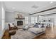 Open-concept living room with stone fireplace, wood beams, hardwood floors, and seamless flow to the kitchen at 1826 Hall Ave, Charlotte, NC 28205