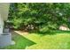 Large backyard featuring a playset, storage sheds, and mature trees at 2131 Lee St, Gastonia, NC 28054