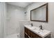 Bathroom with double sink vanity and walk-in shower with marble tile at 2131 Lee St, Gastonia, NC 28054