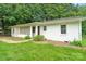 Charming single-story home featuring a white brick facade and a welcoming front porch at 2131 Lee St, Gastonia, NC 28054
