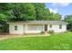 Traditional one story house with a welcoming front porch and manicured lawn at 2131 Lee St, Gastonia, NC 28054