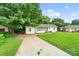 Charming single story home with a well-maintained front lawn and paved driveway at 2131 Lee St, Gastonia, NC 28054