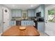 Well-equipped kitchen with granite countertops, stainless appliances, and light blue cabinetry at 2131 Lee St, Gastonia, NC 28054