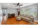 Cozy living room featuring hardwood floors, a comfortable couch, and a ceiling fan at 2131 Lee St, Gastonia, NC 28054