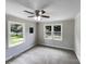 Comfortable bedroom featuring carpet, a ceiling fan, and two large windows for natural light at 2136 W 6Th Ave, Gastonia, NC 28052