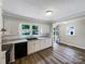 Modern kitchen featuring white cabinets, stone countertops, and stainless steel appliances at 2136 W 6Th Ave, Gastonia, NC 28052