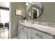 Well-lit bathroom featuring marble countertop, white cabinets, and olive-green walls at 22 Honeysuckle Ln, Clover, SC 29710