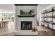 Living room's white brick fireplace with mantle and decor, plus an open floorplan at 22 Honeysuckle Ln, Clover, SC 29710