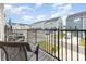 Balcony view of a residential street with townhomes, chairs, and black railings at 2203 Autumn Olive Ln, Stallings, NC 28104