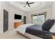Primary bedroom with tray ceiling, a large window, dark wood door, and minimalist decor at 2203 Autumn Olive Ln, Stallings, NC 28104