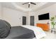 Primary bedroom with tray ceiling, a large window, minimalist decor, and dark wood doors at 2203 Autumn Olive Ln, Stallings, NC 28104