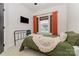 Well-lit bedroom featuring plush carpet, a black metal bed frame, and a window with woven shades at 2203 Autumn Olive Ln, Stallings, NC 28104