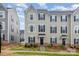 Charming two-story townhome with gray siding, black shutters, and well-maintained landscaping at 2203 Autumn Olive Ln, Stallings, NC 28104
