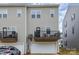 Rear exterior view of a two story townhome with a garage, and upper level balcony at 2203 Autumn Olive Ln, Stallings, NC 28104