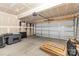 Unfinished garage with a garage door opener, concrete floor, and exposed ceiling at 2203 Autumn Olive Ln, Stallings, NC 28104