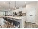 Bright view of the kitchen featuring an island with seating, stainless appliances, and pendant lights at 2203 Autumn Olive Ln, Stallings, NC 28104