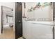 Laundry room featuring white washer and dryer, wire shelving, and view into adjacent bedroom at 2203 Autumn Olive Ln, Stallings, NC 28104
