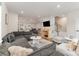 Open-concept living room with modern sectional, fireplace, and view of the dining area at 2203 Autumn Olive Ln, Stallings, NC 28104