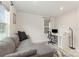 Cozy home office with gray sectional, desk, and natural light at 2203 Autumn Olive Ln, Stallings, NC 28104