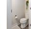Compact powder room featuring a toilet and a hanging plant at 2203 Autumn Olive Ln, Stallings, NC 28104