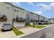 Street view of townhomes with garages, balconies, and well-manicured lawns at 2203 Autumn Olive Ln, Stallings, NC 28104