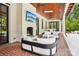 Expansive covered patio boasts a fireplace, comfortable seating, and outdoor dining area for entertaining at 2215 Cortelyou Rd, Charlotte, NC 28211