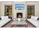Inviting covered patio features a brick fireplace, comfortable seating, and outdoor television for entertainment at 2215 Cortelyou Rd, Charlotte, NC 28211
