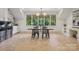 Bright dining area with large windows, modern lighting, and a view of the outdoors at 2215 Cortelyou Rd, Charlotte, NC 28211