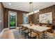Modern dining room featuring modern light fixture, seating for six, and herringbone wallpaper at 2215 Cortelyou Rd, Charlotte, NC 28211