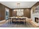 Stylish dining room featuring modern light fixture, seating for six, and herringbone wallpaper at 2215 Cortelyou Rd, Charlotte, NC 28211