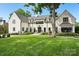 Charming white brick home with well-manicured lawn and stone walkway leading to the front door at 2215 Cortelyou Rd, Charlotte, NC 28211
