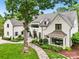 Elegant home with manicured front yard, stone pathway, and charming architectural details enhancing curb appeal at 2215 Cortelyou Rd, Charlotte, NC 28211