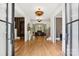 Grand foyer showcasing hardwood floors, elegant lighting, and views into multiple living spaces at 2215 Cortelyou Rd, Charlotte, NC 28211