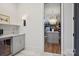 Hallway connecting a sink and mini fridge, with a doorway leading to the walk in closet at 2215 Cortelyou Rd, Charlotte, NC 28211