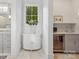 Hallway with a small sink and mini fridge, a marble floor, and a window to the backyard at 2215 Cortelyou Rd, Charlotte, NC 28211