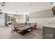 Spacious entertainment room with comfortable seating, pool table, and stylish wet bar perfect for relaxation at 2215 Cortelyou Rd, Charlotte, NC 28211