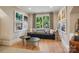 Cozy living room with stylish decor, hardwood floors, and natural light from a large window at 2215 Cortelyou Rd, Charlotte, NC 28211