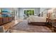 Bright main bedroom boasts hardwood floors, area rug, television and view of the property at 2215 Cortelyou Rd, Charlotte, NC 28211