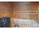 Relaxing sauna room featuring wood paneled walls, built-in bench seating, and traditional sauna heater at 2215 Cortelyou Rd, Charlotte, NC 28211