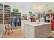 Bright walk-in closet features custom shelving, hardwood floors, and a closet island at 2215 Cortelyou Rd, Charlotte, NC 28211