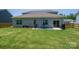 Expansive backyard featuring a patio with outdoor seating and lush green grass, ideal for outdoor activities at 250 Winford Rd, Troutman, NC 28166
