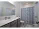 Bright bathroom features a single sink, modern fixtures, and a blue floral shower curtain for a fresh look at 250 Winford Rd, Troutman, NC 28166
