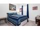 Bedroom with natural light is decorated with two framed pictures, and a blue comforter at 250 Winford Rd, Troutman, NC 28166