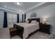 Bedroom with tray ceiling, and wooden furnishings, with neutral-toned walls and accents at 250 Winford Rd, Troutman, NC 28166