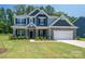 Charming two-story home with stone accents, manicured lawn, and a welcoming front porch at 250 Winford Rd, Troutman, NC 28166
