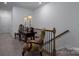 Well-lit hallway with decorative table and chairs by the railing at 250 Winford Rd, Troutman, NC 28166