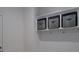 Hallway with a white wall, gray storage boxes and hooks at 250 Winford Rd, Troutman, NC 28166