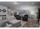 Open-concept living area with plush seating, modern finishes, and seamless access to the kitchen at 250 Winford Rd, Troutman, NC 28166