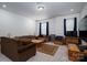 Spacious living room with large sectional sofa, coffee table, TV and mini-refrigerator at 250 Winford Rd, Troutman, NC 28166
